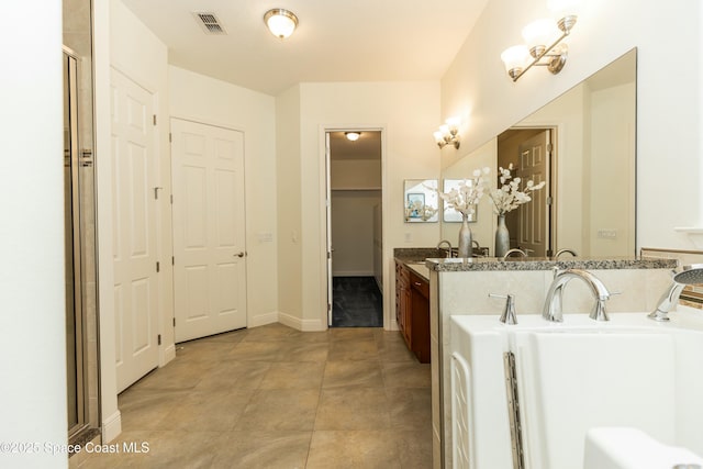 bathroom featuring vanity and a chandelier