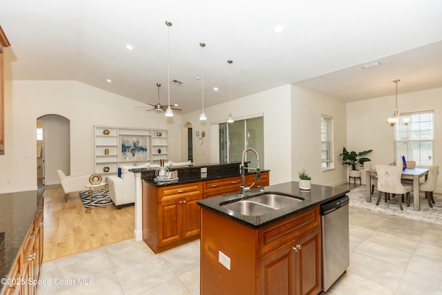 kitchen featuring decorative light fixtures, sink, an island with sink, and dishwasher