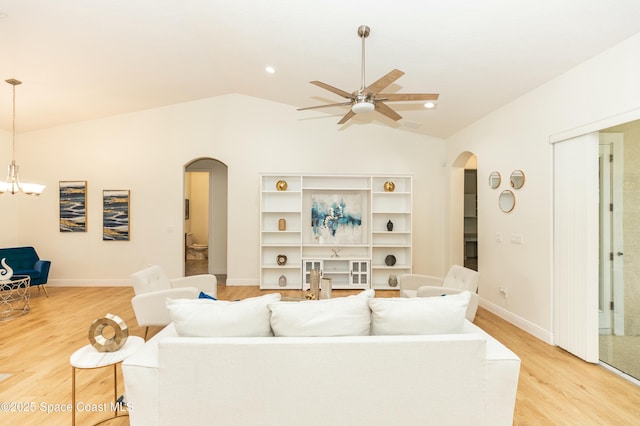 living room with ceiling fan, lofted ceiling, and light hardwood / wood-style flooring