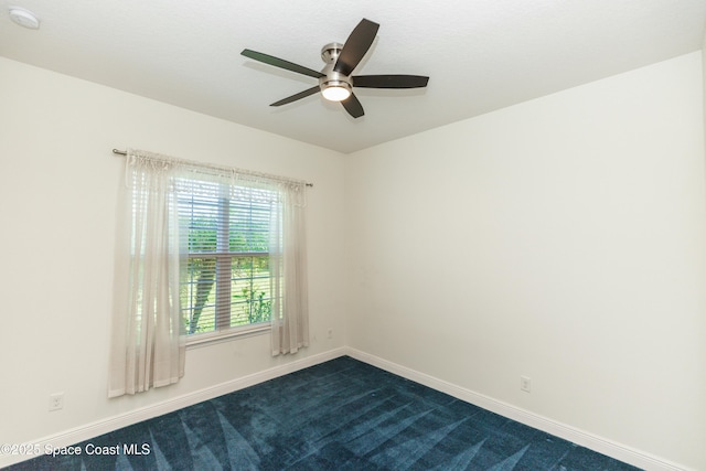 empty room featuring carpet flooring and ceiling fan