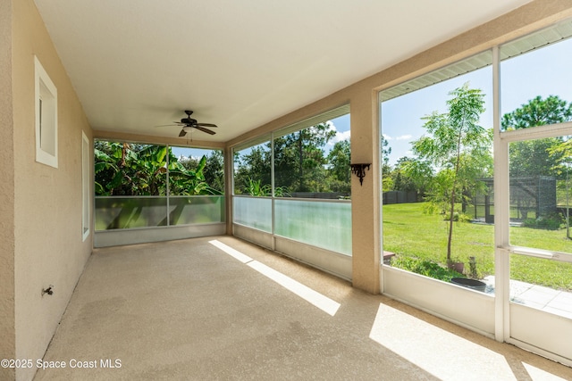 unfurnished sunroom with ceiling fan