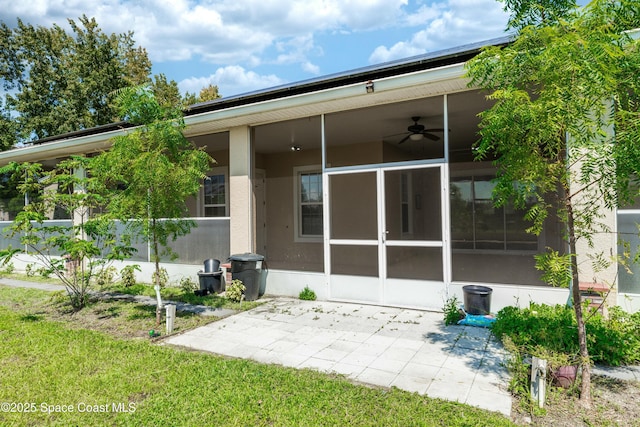 rear view of house featuring a sunroom, ceiling fan, and a yard