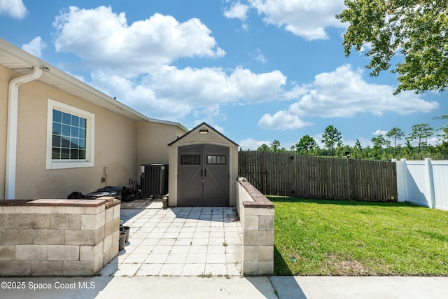 exterior space with central AC and a storage unit