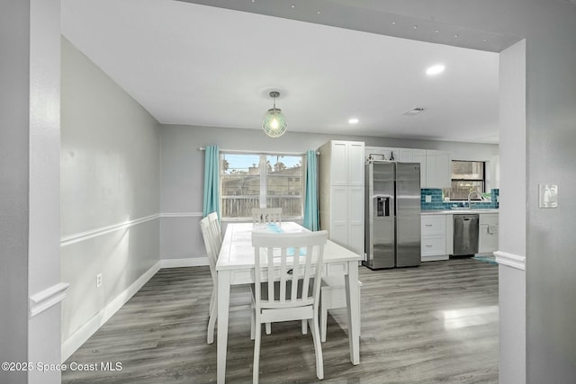 unfurnished dining area featuring sink and hardwood / wood-style floors