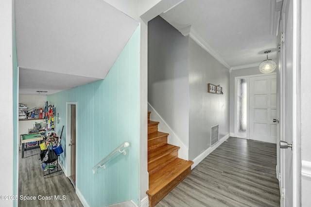 entryway with hardwood / wood-style flooring and ornamental molding