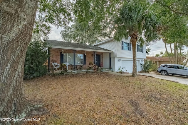 tri-level home featuring a porch and a garage