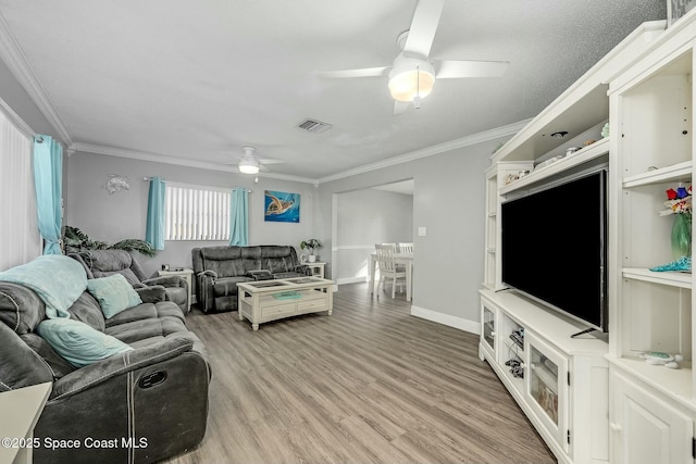 living room featuring ceiling fan, crown molding, and light hardwood / wood-style flooring