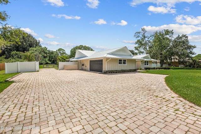 single story home with a front lawn and a garage