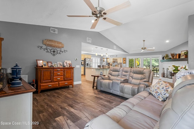 living room with vaulted ceiling, ceiling fan, a fireplace, and dark hardwood / wood-style floors