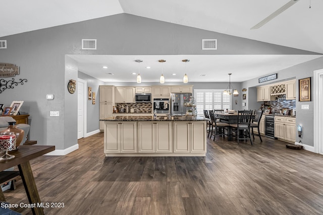 kitchen with stainless steel appliances, wine cooler, cream cabinets, pendant lighting, and decorative backsplash