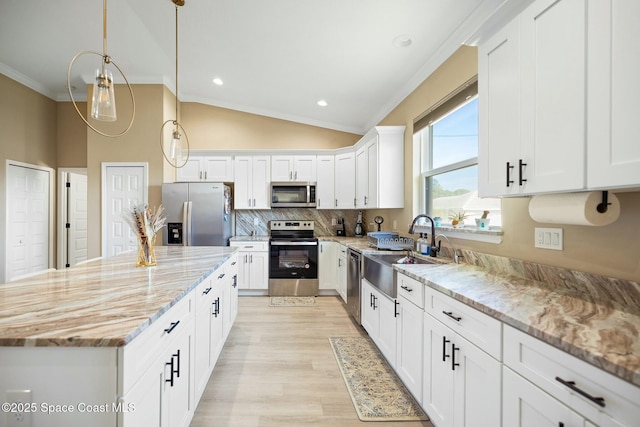 kitchen with light stone countertops, appliances with stainless steel finishes, backsplash, pendant lighting, and white cabinets