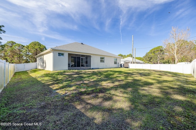 rear view of house with a yard