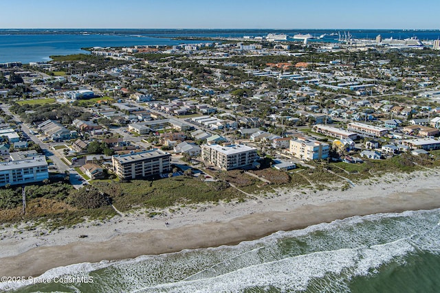 birds eye view of property featuring a water view and a beach view