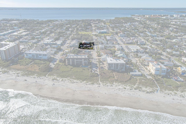 bird's eye view featuring a water view and a view of the beach