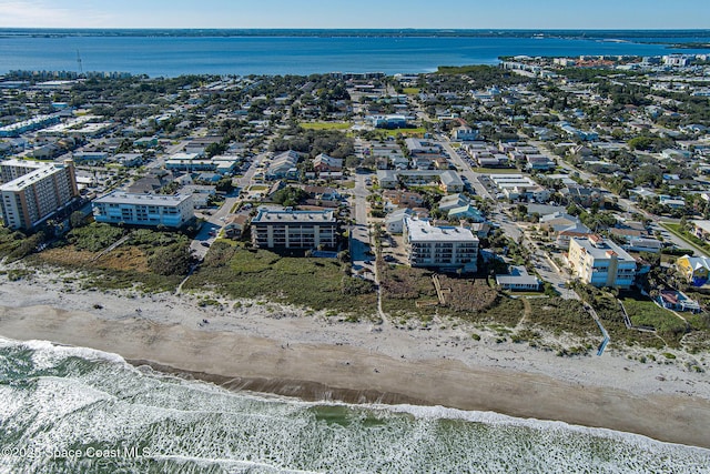 birds eye view of property featuring a water view and a view of the beach