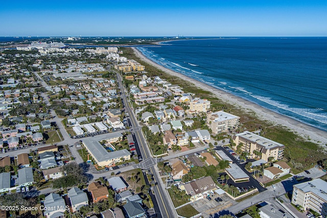 birds eye view of property with a beach view and a water view