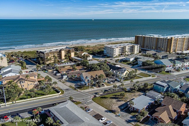 aerial view with a water view and a beach view