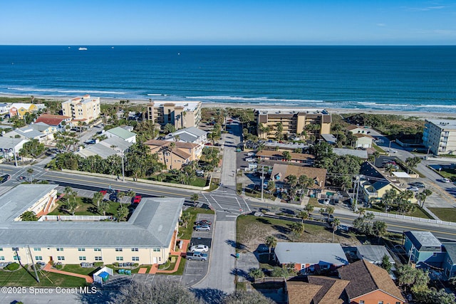 birds eye view of property with a view of the beach and a water view