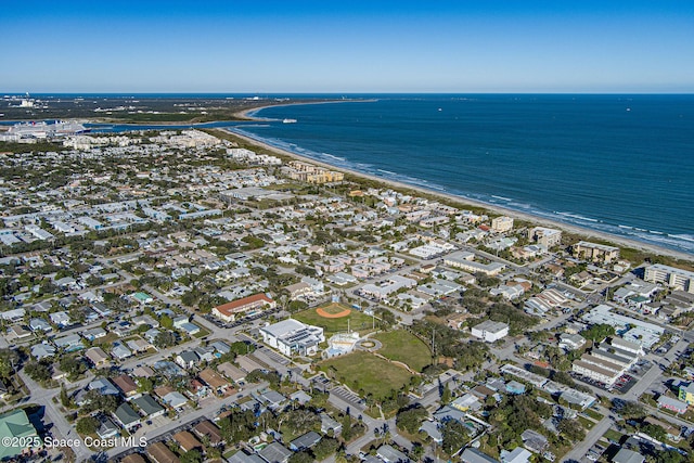 bird's eye view with a water view and a beach view