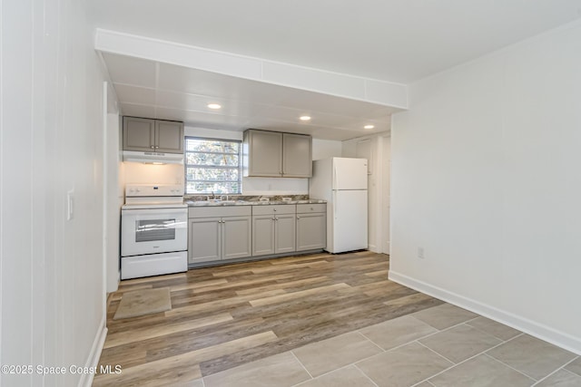 kitchen featuring gray cabinetry, white appliances, sink, and light hardwood / wood-style flooring