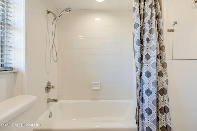 bathroom featuring shower / bath combo and toilet