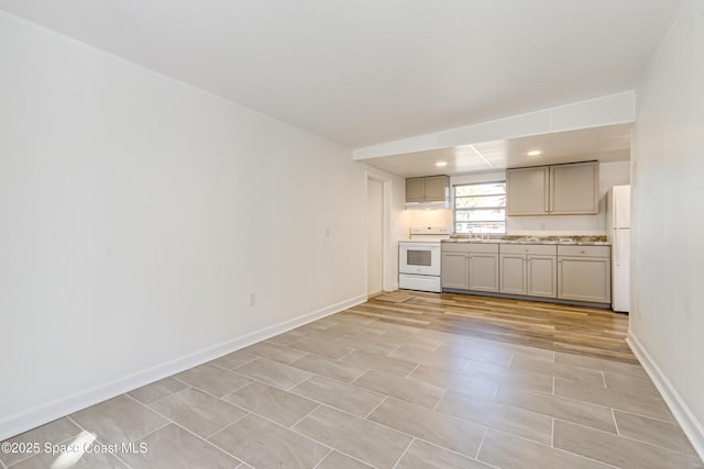 kitchen with white appliances and gray cabinetry