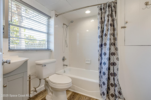 full bathroom featuring hardwood / wood-style floors, toilet, shower / bath combo with shower curtain, and a wealth of natural light