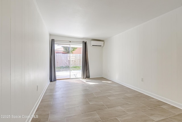 spare room featuring a wall mounted air conditioner and wood walls