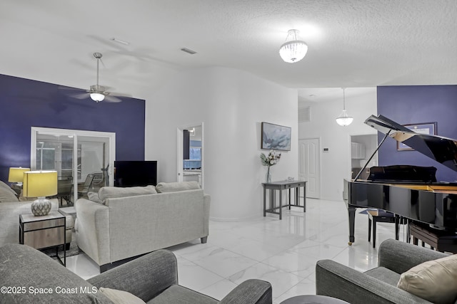 living room with lofted ceiling, ceiling fan, and a textured ceiling