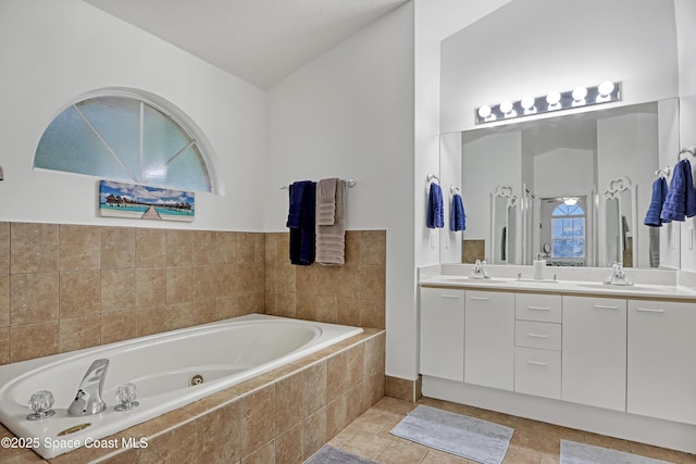 bathroom featuring vanity, tiled bath, and tile patterned floors