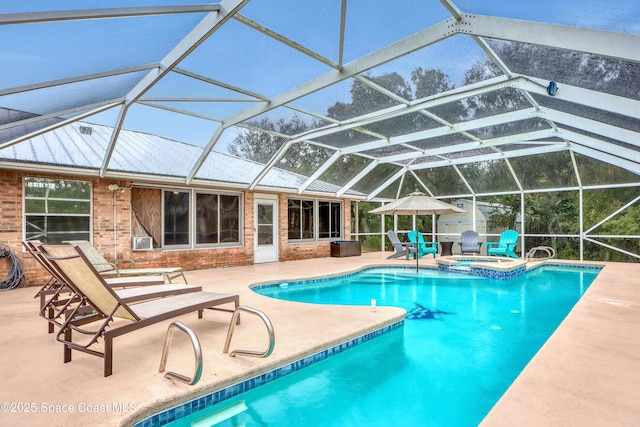 view of pool featuring an in ground hot tub, a lanai, and a patio area