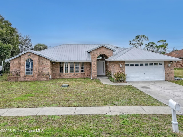 ranch-style home featuring an attached garage, a front lawn, driveway, and metal roof