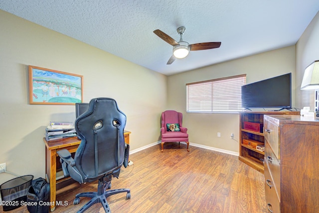 home office with hardwood / wood-style floors, a textured ceiling, and ceiling fan