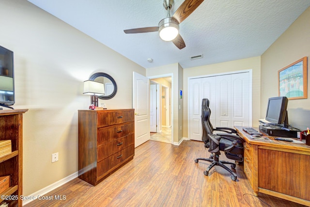 home office featuring ceiling fan and light hardwood / wood-style flooring