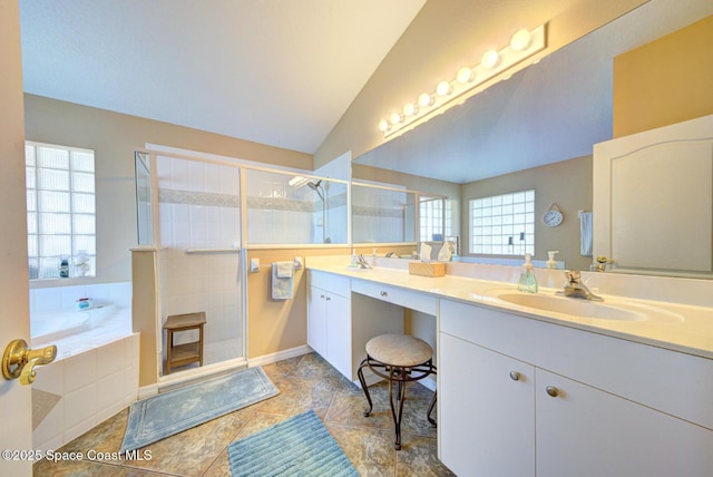 bathroom featuring vanity, a healthy amount of sunlight, vaulted ceiling, and shower with separate bathtub