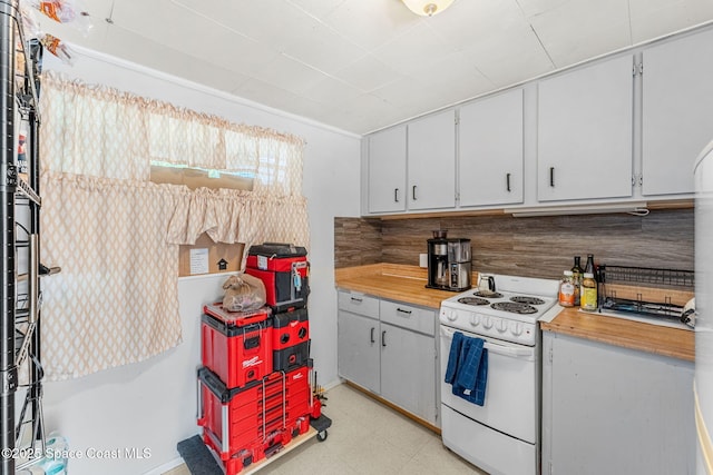 kitchen featuring decorative backsplash and white stove