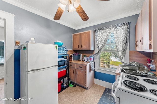 kitchen featuring ceiling fan, crown molding, and white appliances