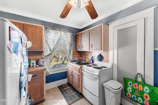 kitchen featuring decorative backsplash, ceiling fan, white appliances, and ornamental molding