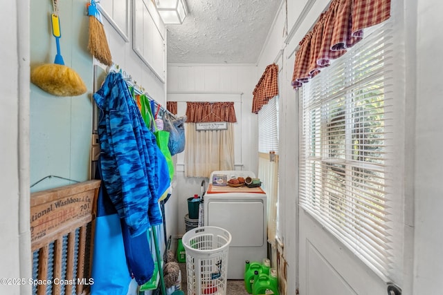 laundry area featuring washer / clothes dryer and a textured ceiling