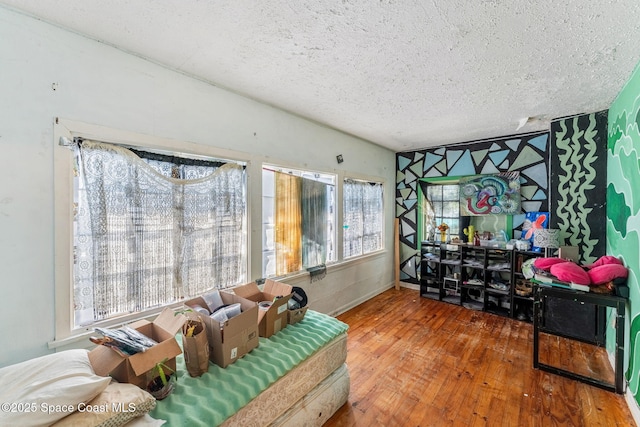 living room featuring hardwood / wood-style floors, a textured ceiling, and a wealth of natural light