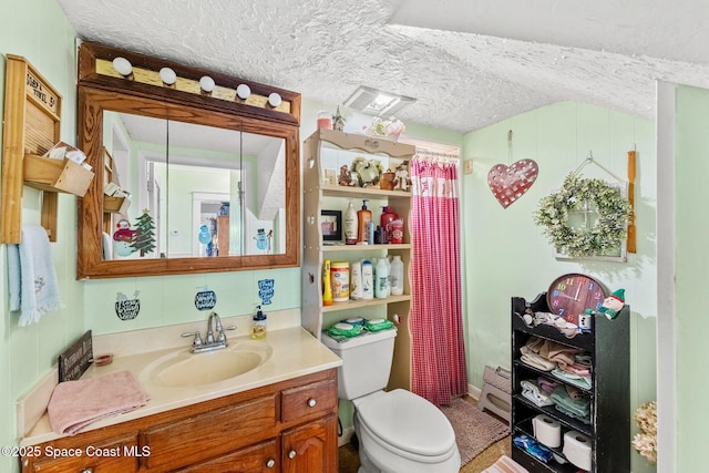 bathroom with vanity, a textured ceiling, and toilet