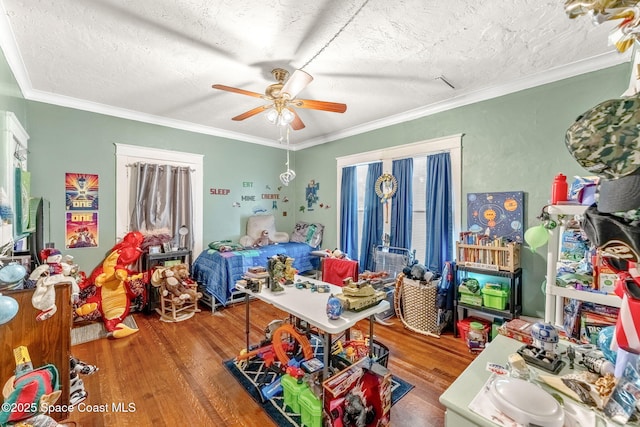 bedroom with a textured ceiling, ceiling fan, crown molding, and hardwood / wood-style flooring