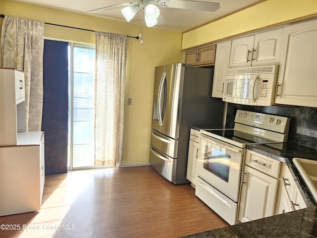 kitchen with backsplash, ceiling fan, light hardwood / wood-style flooring, and white appliances