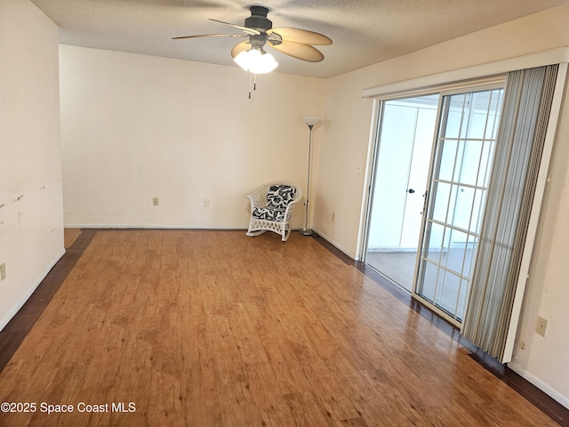 unfurnished room featuring hardwood / wood-style floors, a textured ceiling, and ceiling fan