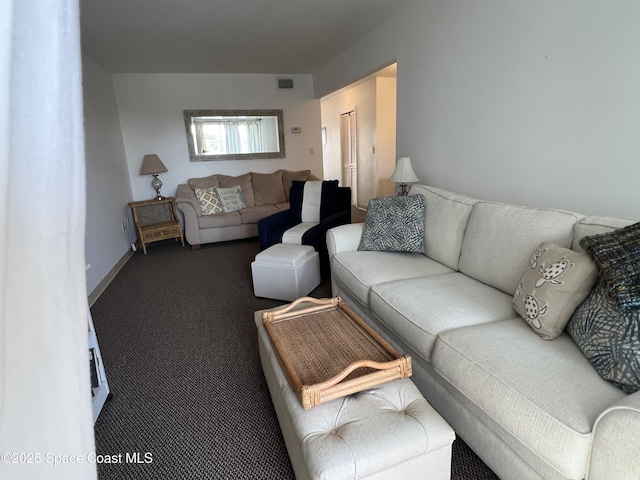 living room featuring dark colored carpet