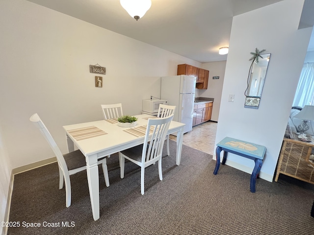 dining space featuring light colored carpet