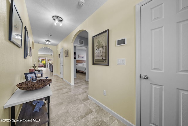 hallway featuring a textured ceiling