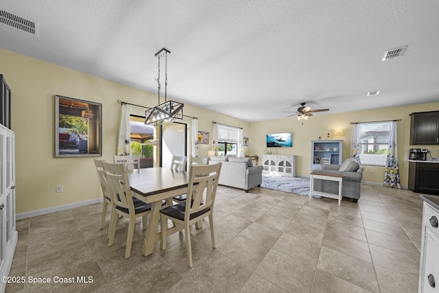 dining room with ceiling fan and a textured ceiling