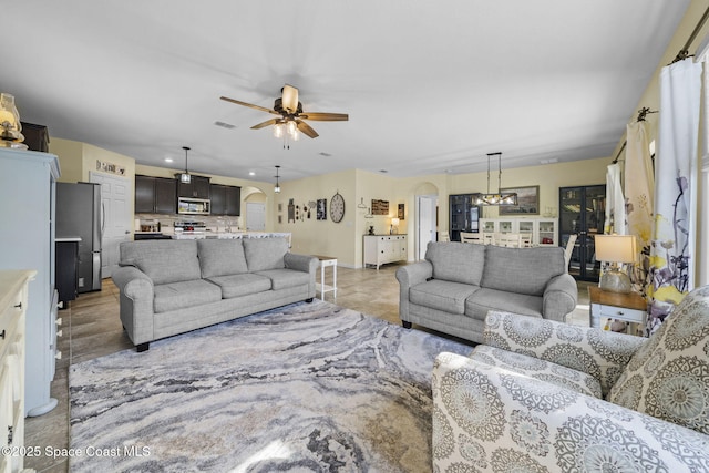 tiled living room featuring ceiling fan