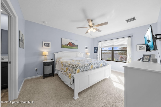 bedroom featuring ceiling fan and light carpet